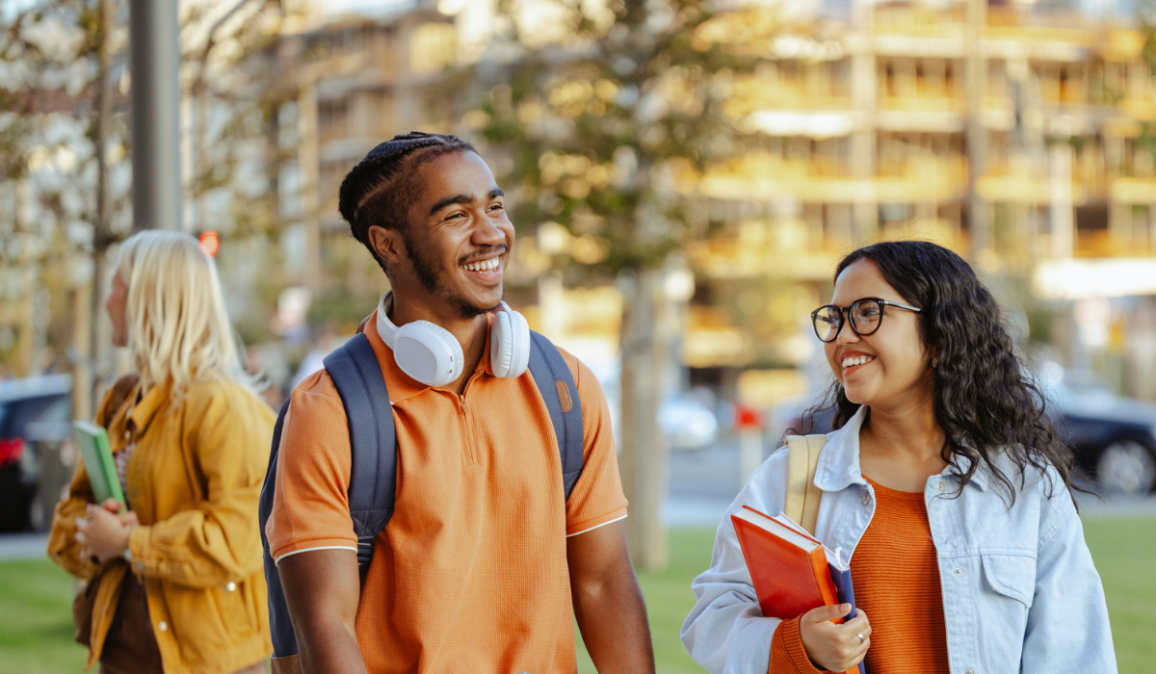 Diverse male and female student chatting on the street.